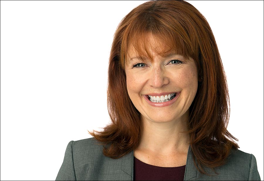 LinkedIn headshot of a woman smiling and with personality