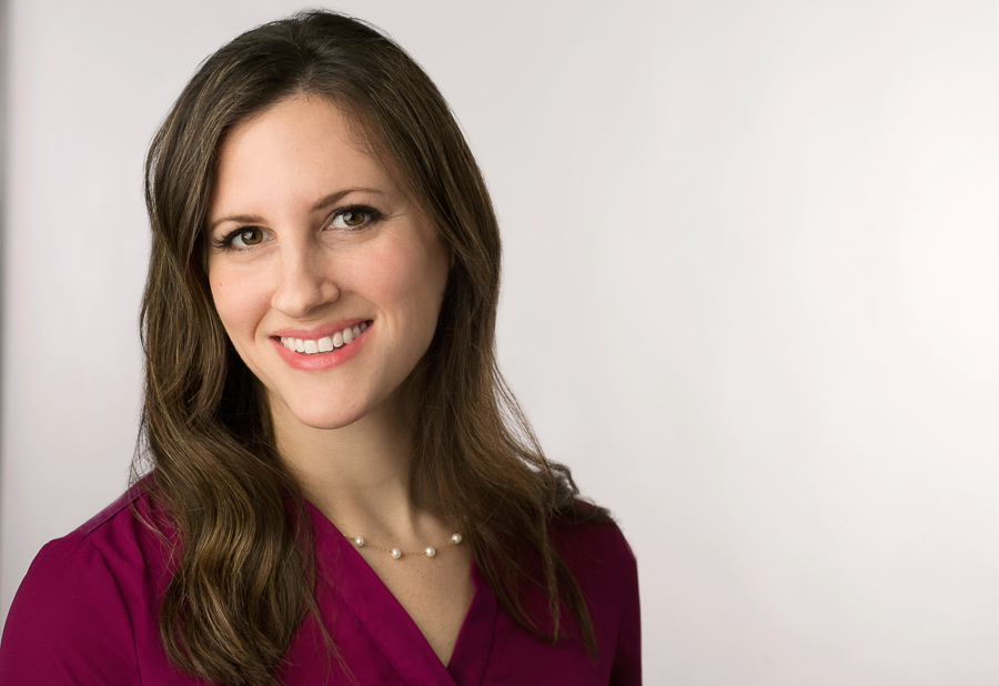 Headshot on a light grey background of a young woman in Baltimore 
